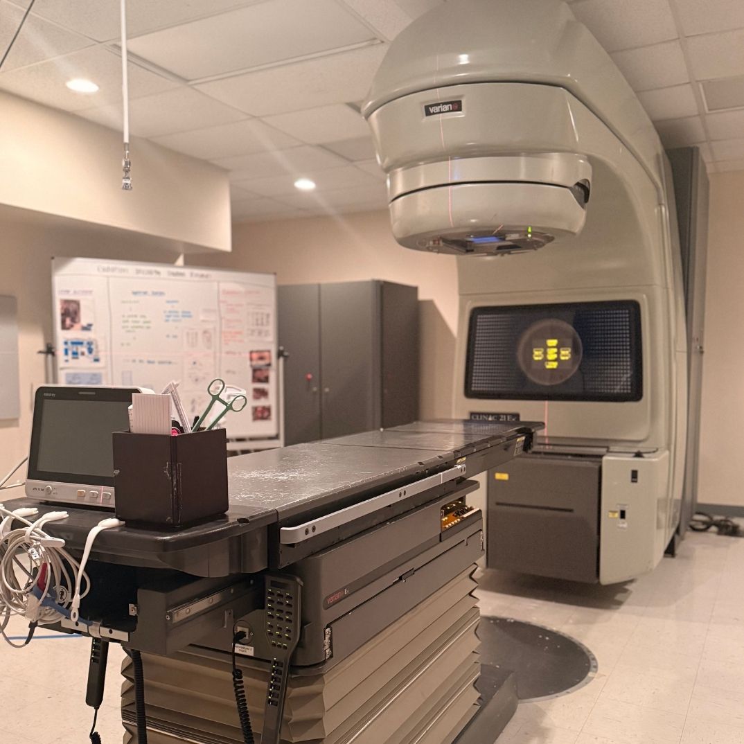A radiotherapy machine with a patient table in a treatment room